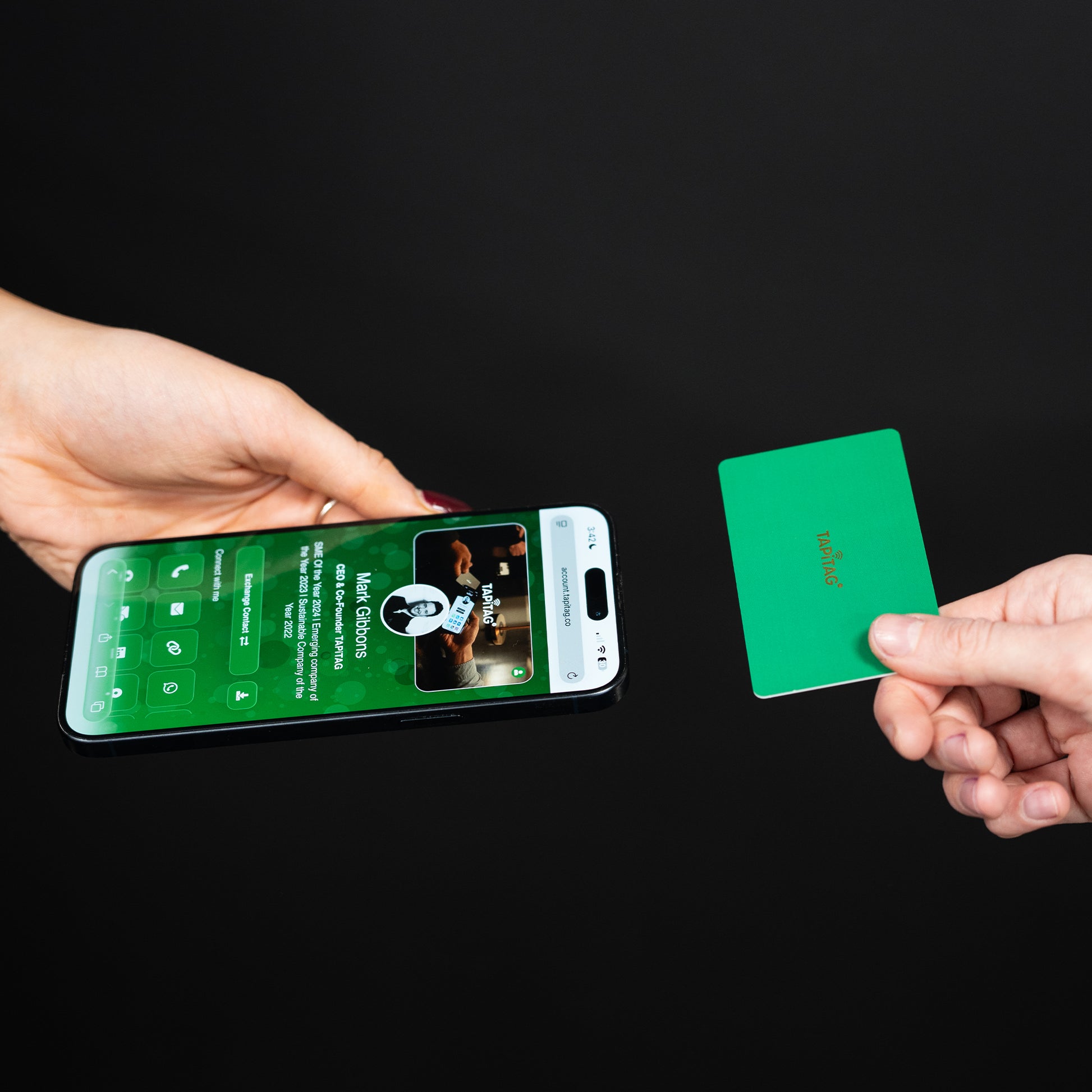 Smartphone displaying a TAPiTAG interface with a Green Digital Business  Card in the background