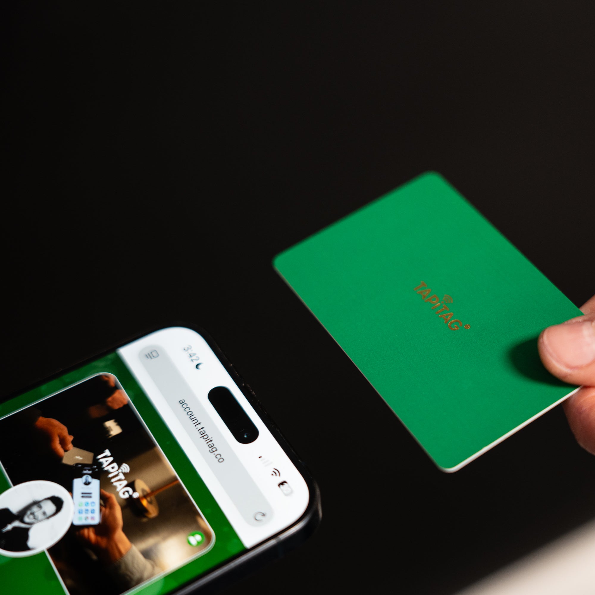 Smartphone displaying a TAPiTAG interface with a Green Digital Business  Card in the background