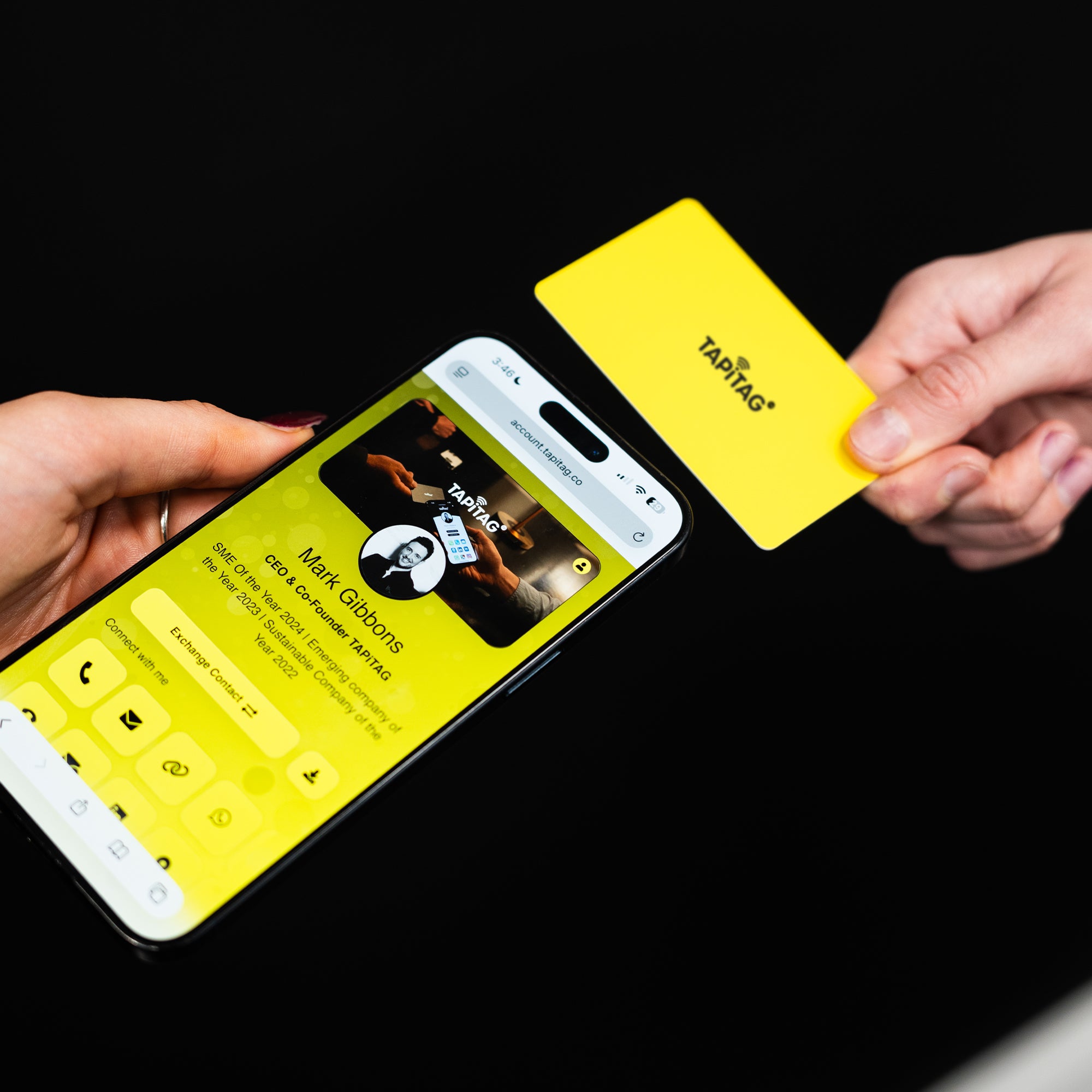 Smartphone displaying a TAPiTAG interface with a yellow Digital Business  Card in the background
