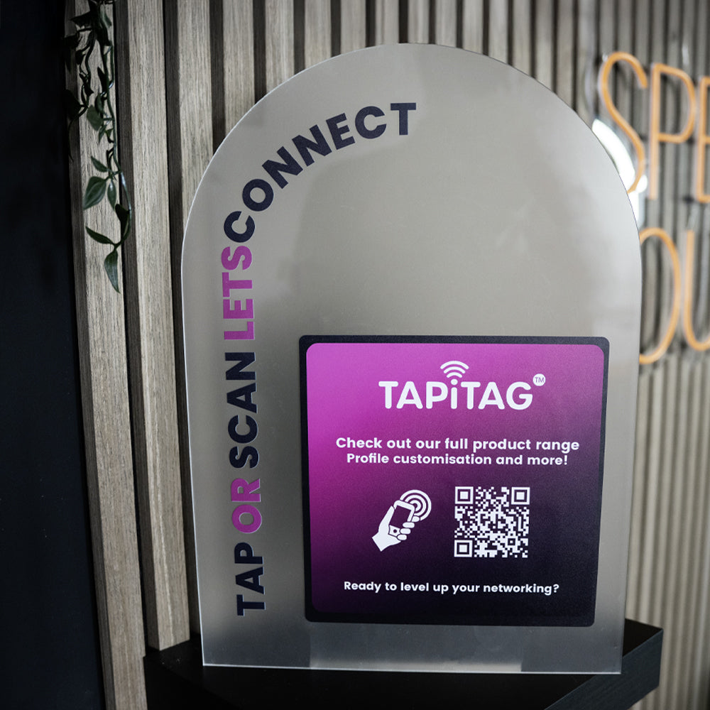 TapITAG device with digital display and branding on a stand.