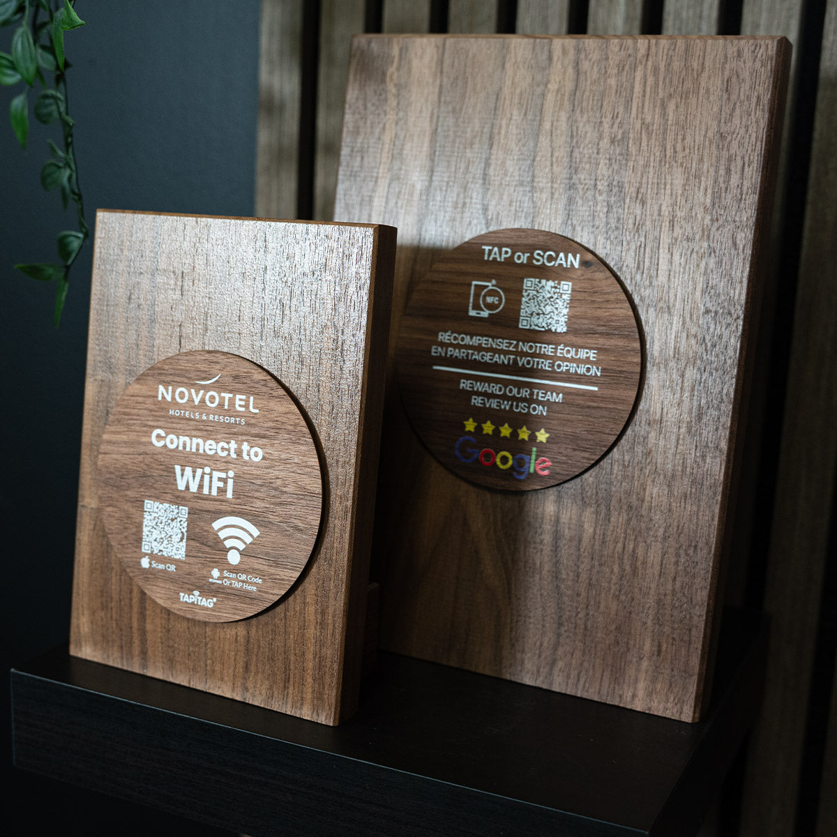 Wooden TAPiTAG  plaque with QR codes and text for Novotel WiFi connection and Google reviews.