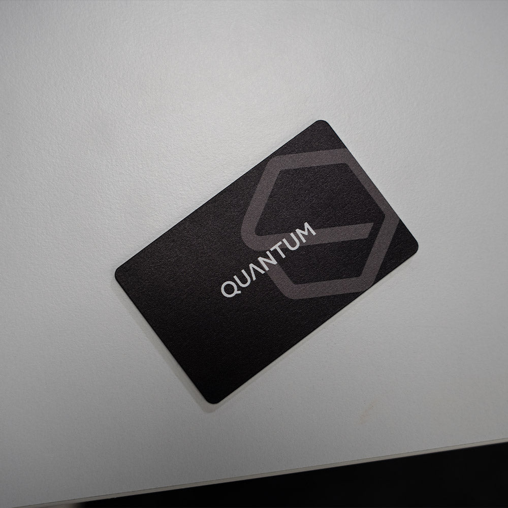 Black card with 'Quantum' logo on a light gray background. TAPiTAG Digital Business Card Bamboo