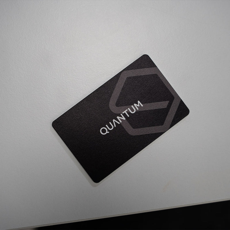 Black card with 'Quantum' logo on a light gray background. TAPiTAG Digital Business Card Bamboo