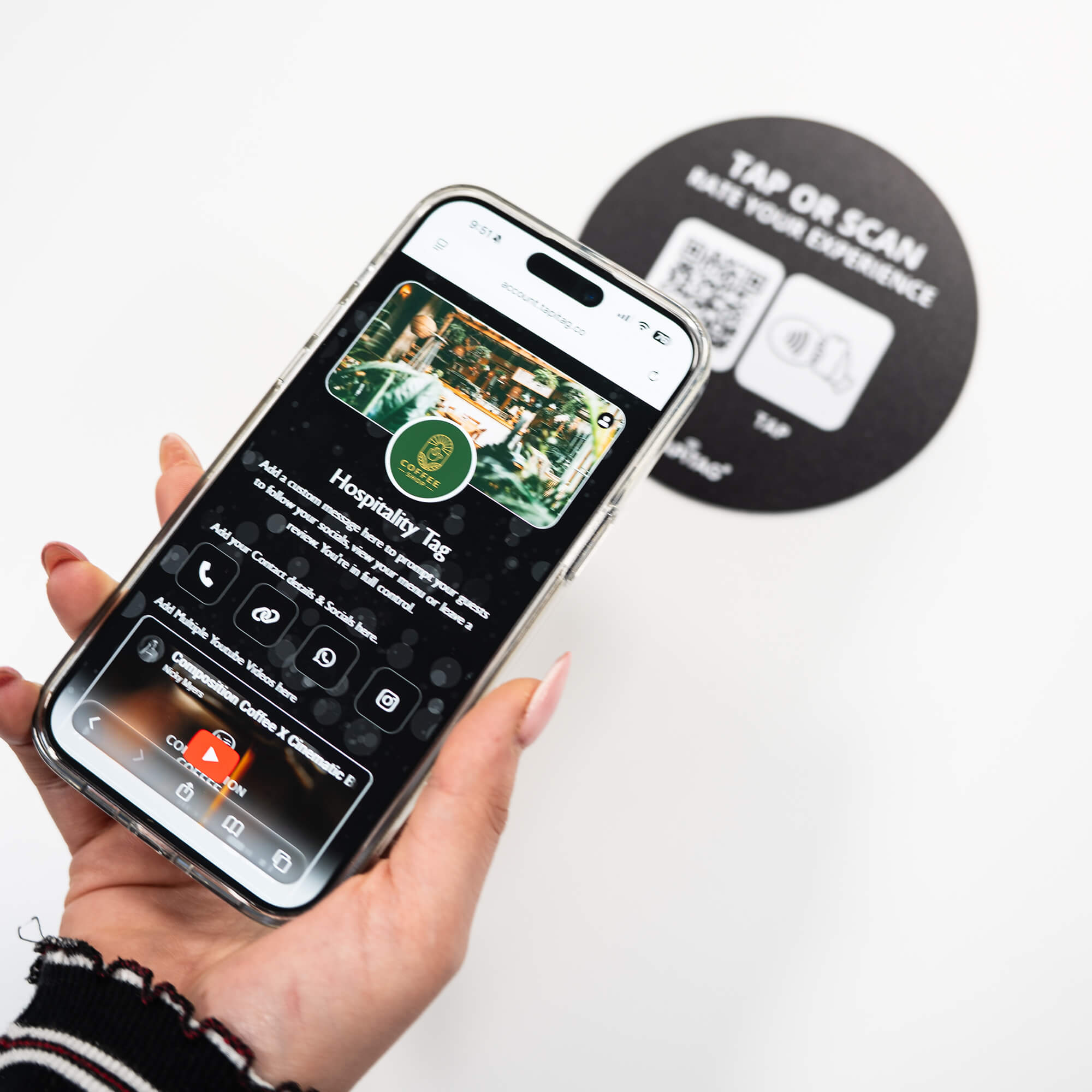Person tapping TAPiTAG NFC hospitality tag with smartphone to access digital business profile instantly
