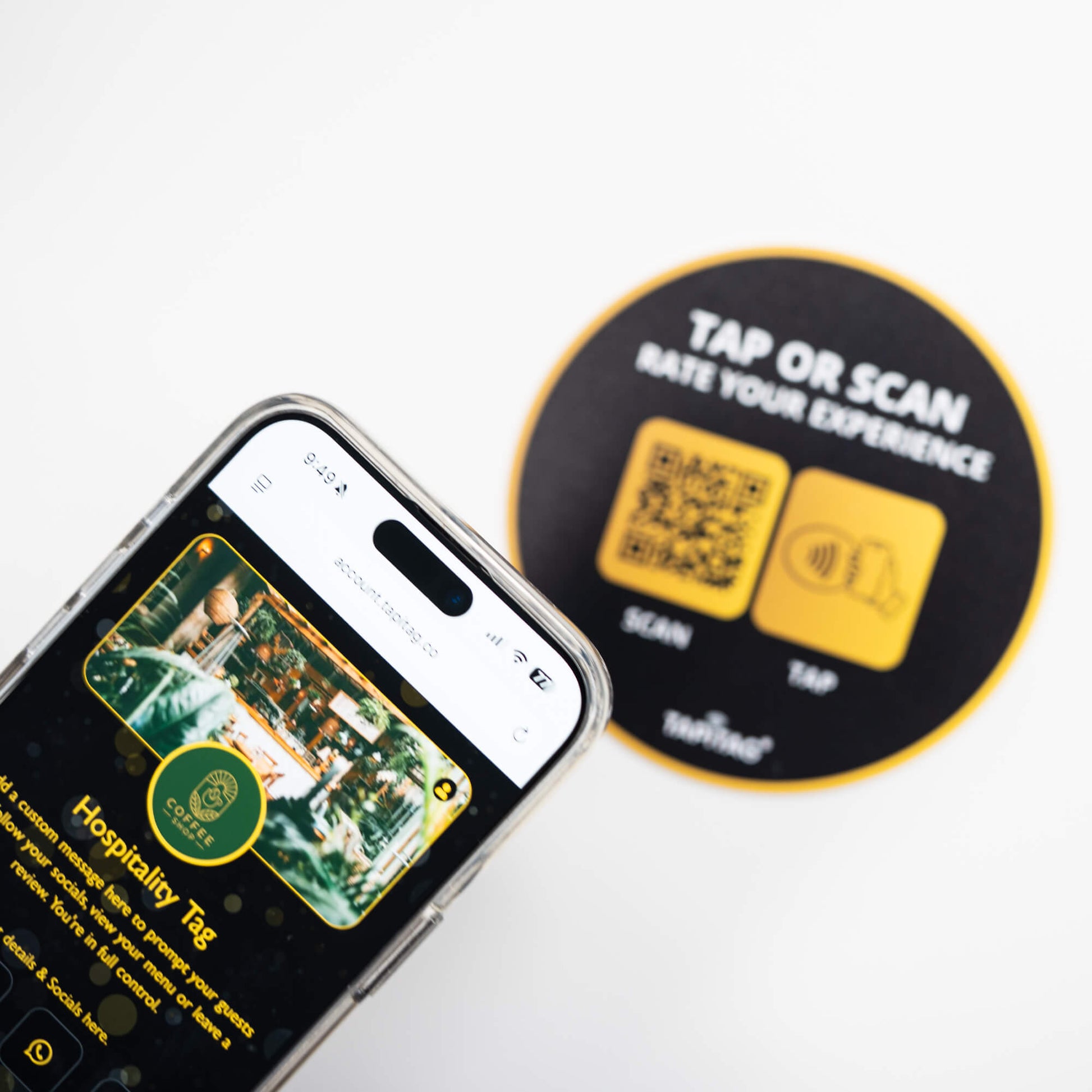 Person tapping TAPiTAG NFC hospitality tag with smartphone to access digital business profile instantly