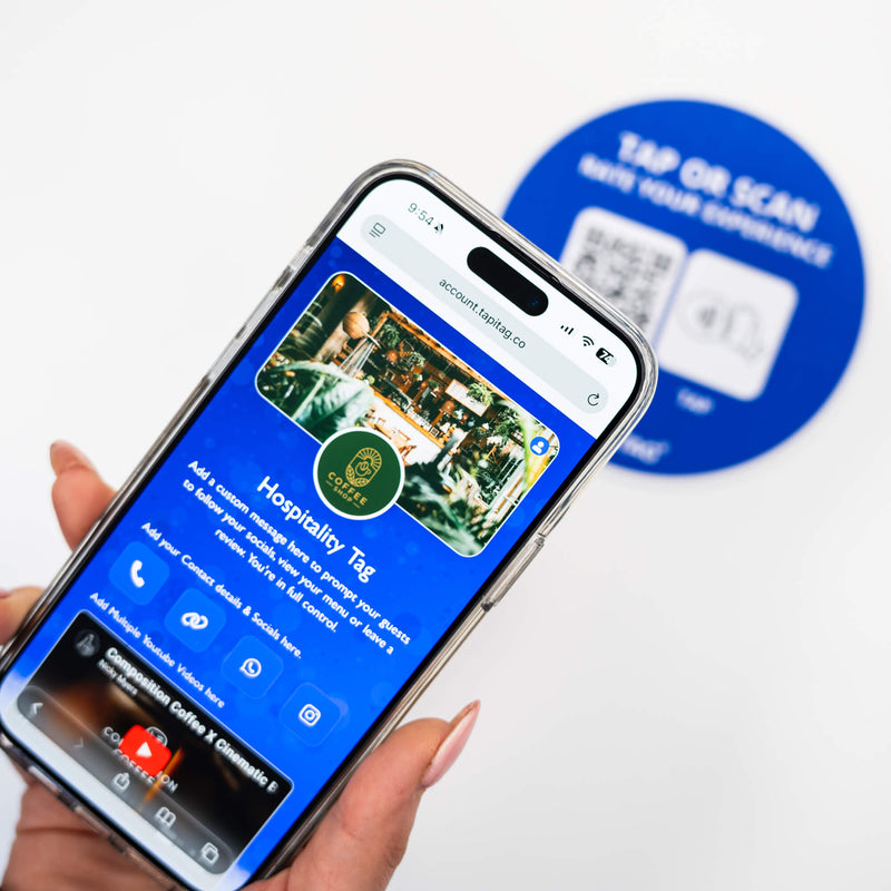 Person tapping TAPiTAG NFC hospitality tag with smartphone to access digital business profile instantly