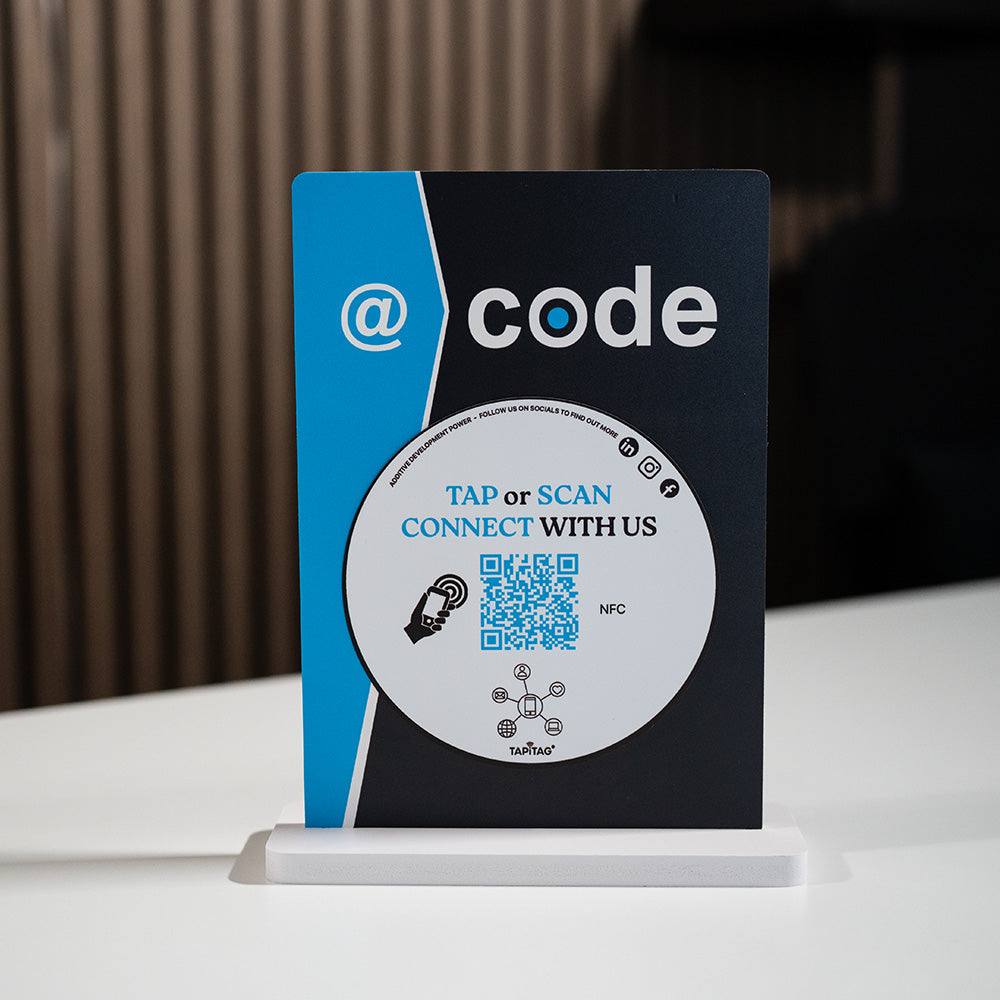 Promotional standee with 'code' branding and QR code on a white surface.