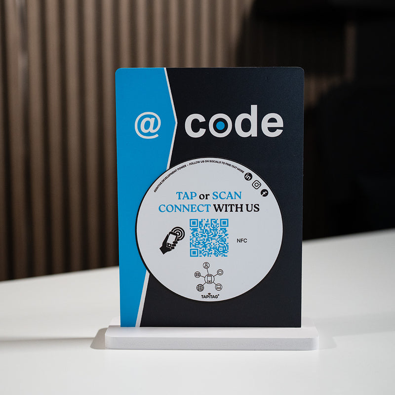 Promotional standee with 'code' branding and QR code on a white surface.