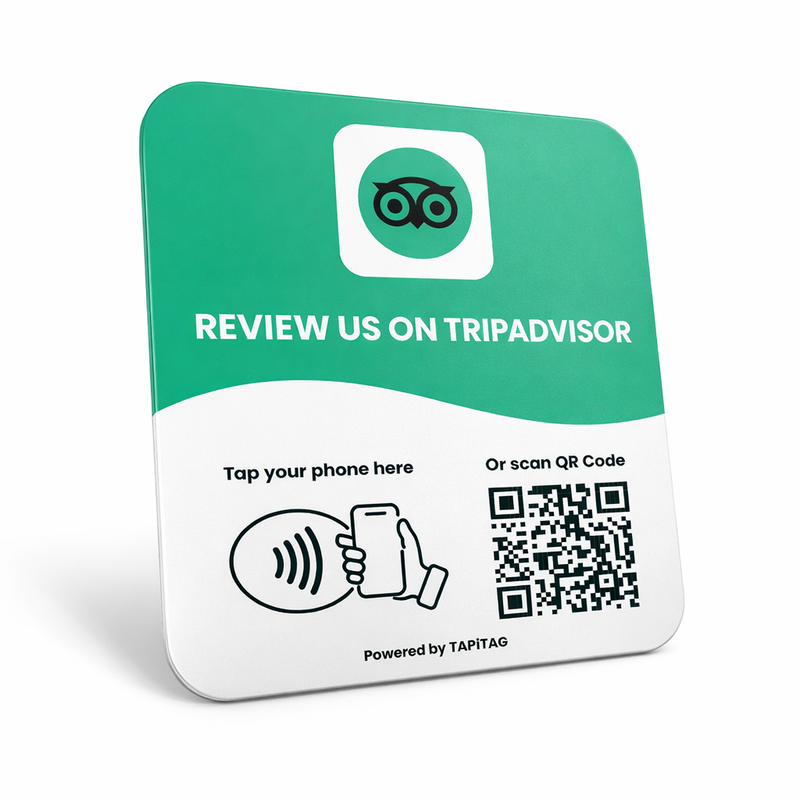 TripAdvisor  NFC tap-to-review plate by TAPiTAG with QR code, allowing customers to tap or scan to instantly review a business on TripAdvisor , displayed on a white counter.