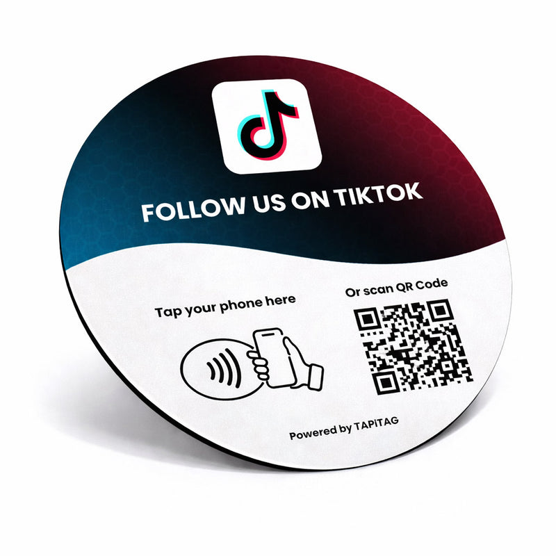 TIKTOK NFC tap-to-follow plate by TAPiTAG with QR code, allowing customers to tap or scan to instantly follow a business on TIKTOK, displayed on a white counter.