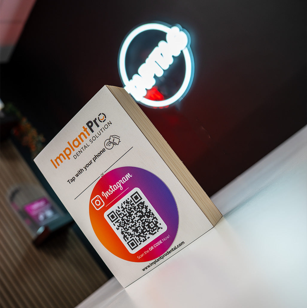 Product packaging with ImplantPro branding and QR code on a blurred background