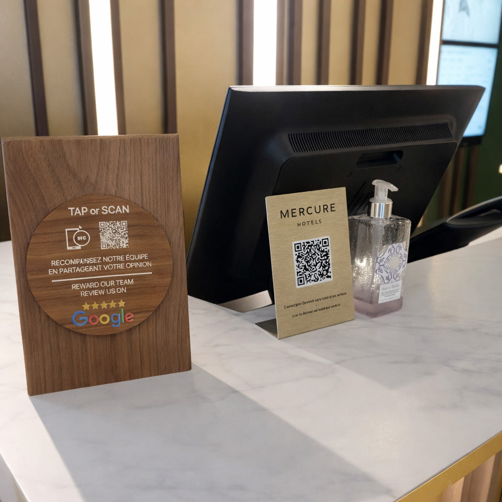 TAPiTAG NFC display stand on a hotel reception desk allowing guests to tap or scan a QR code to connect, leave reviews or access digital services.