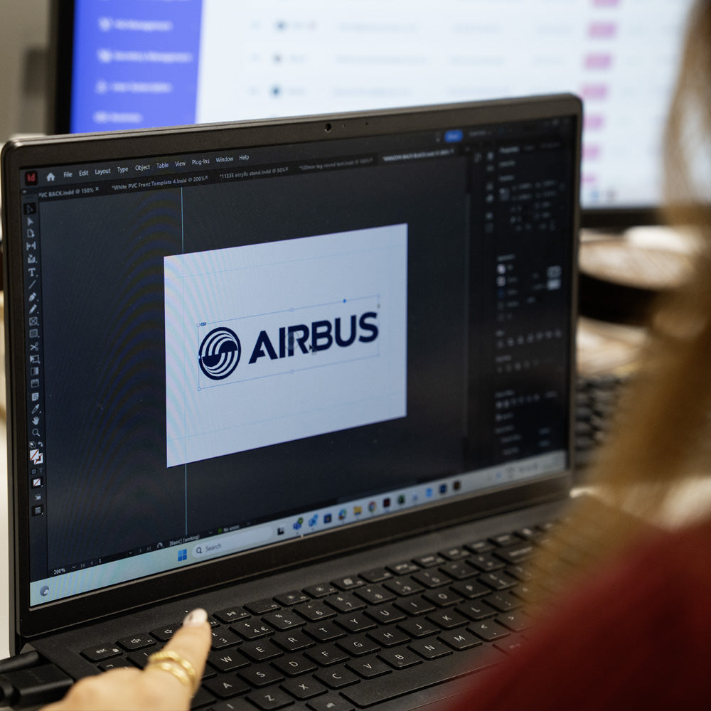 Person using a laptop with Airbus logo on the screen designing TAPiTAG Digital Business Card 