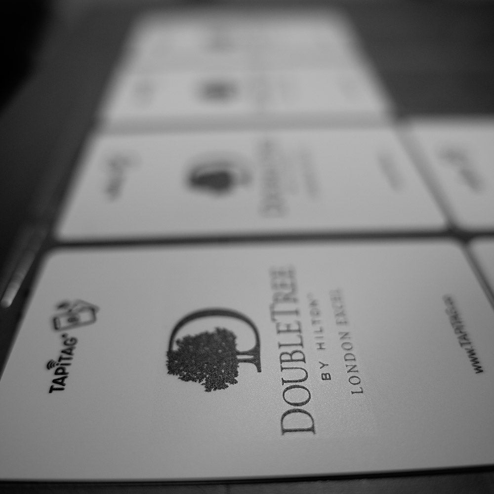 Close-up of DoubleTree by Hilton branded cards with Tapitag logo.