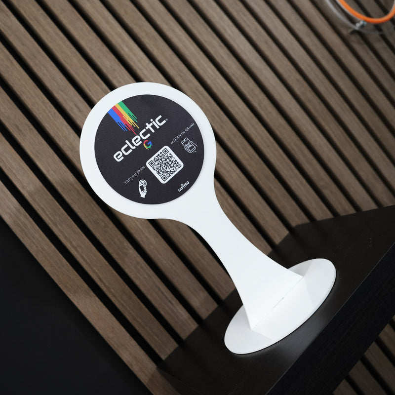 TAPiTAG Smart NFC Display Stand on a wooden Shelf