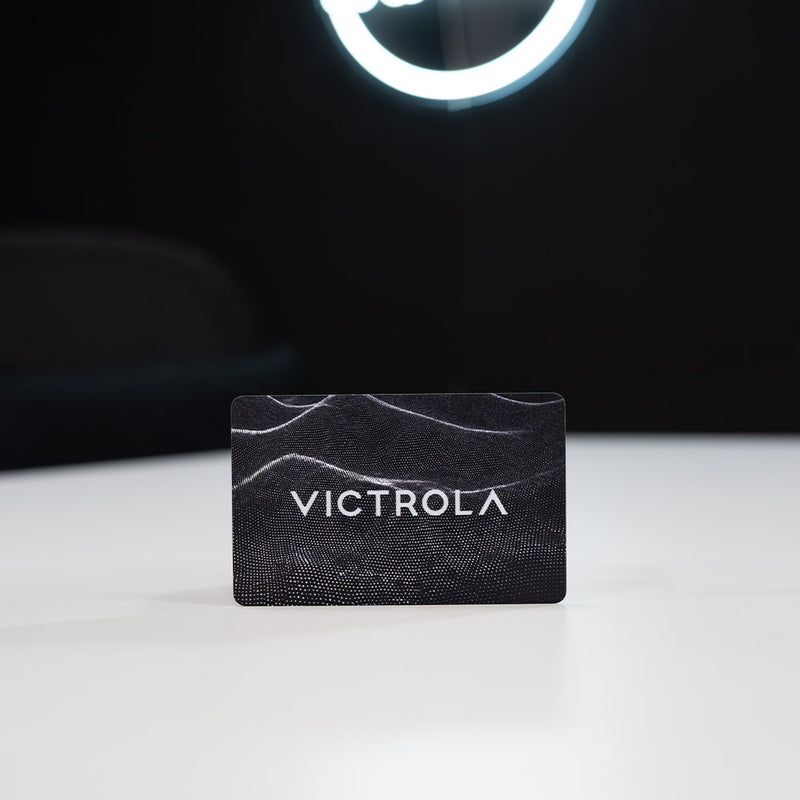 Plastic Digital Business Card, also known as an NFC Business Card Black card with 'VICTROLA' branding on a white surface with a dark background
