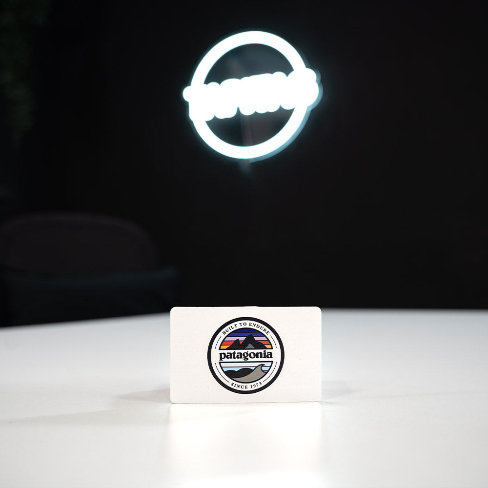 Bamboo Wooden Digital Business Card, also known as an NFC Business Card with Patagonia logo on a white block with a dark background