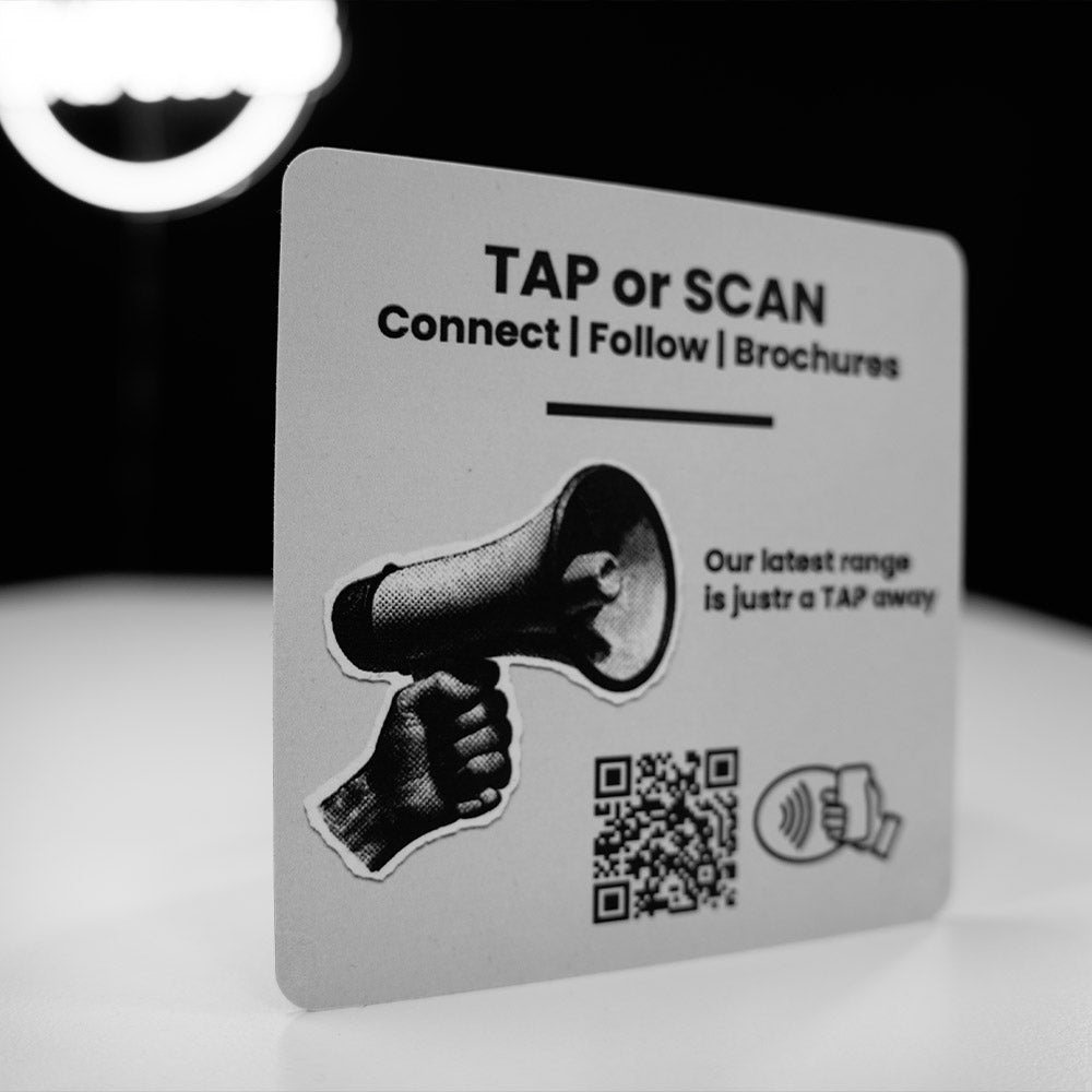 Promotional  nfc tag card with QR code and text 'TAP or SCAN Connect Follow Brochures' on a white background.