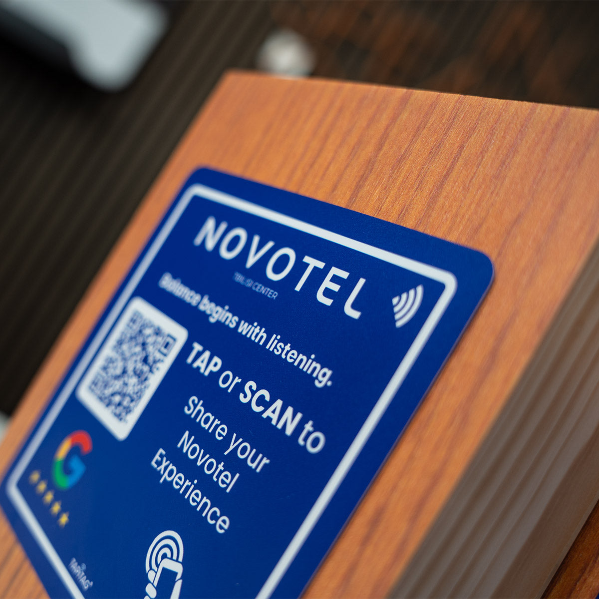 TAPiTAG Smart Display Stand with Novotel  Google Review NFC Tag placed on front