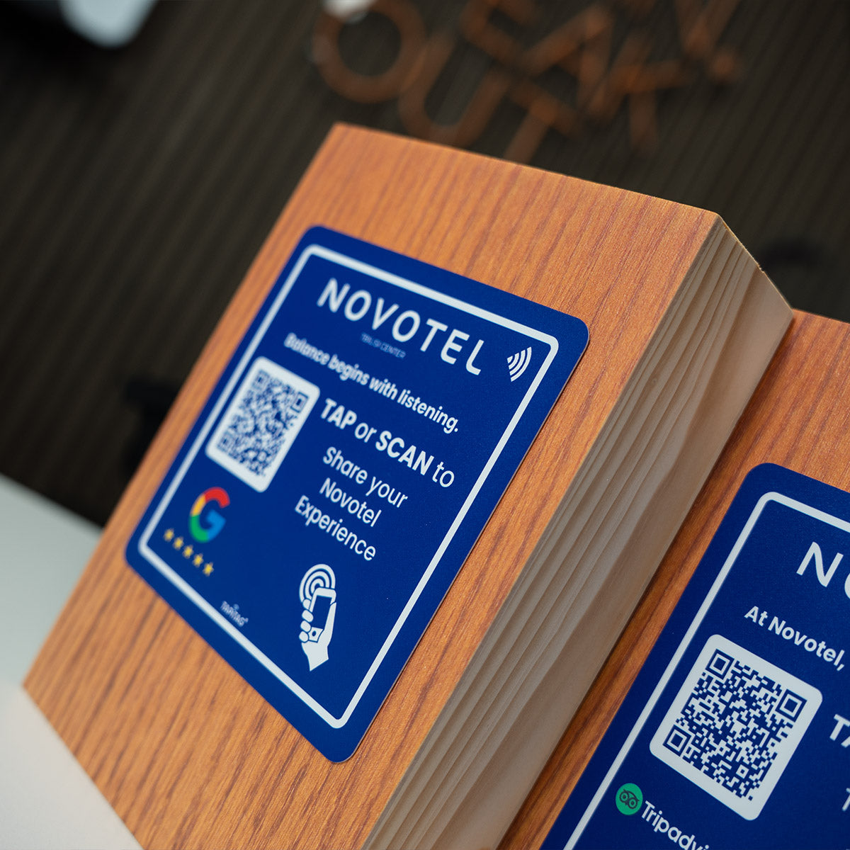TAPiTAG Smart Display Stand with Novotel  Google Review NFC Tag placed on front