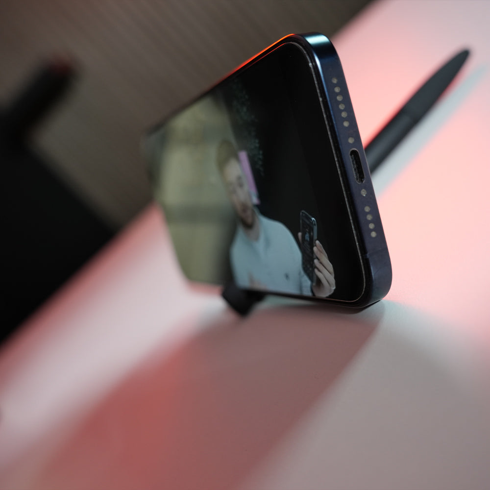 TAPiTAG Smart pen with NFC in sitting in pens phone stand