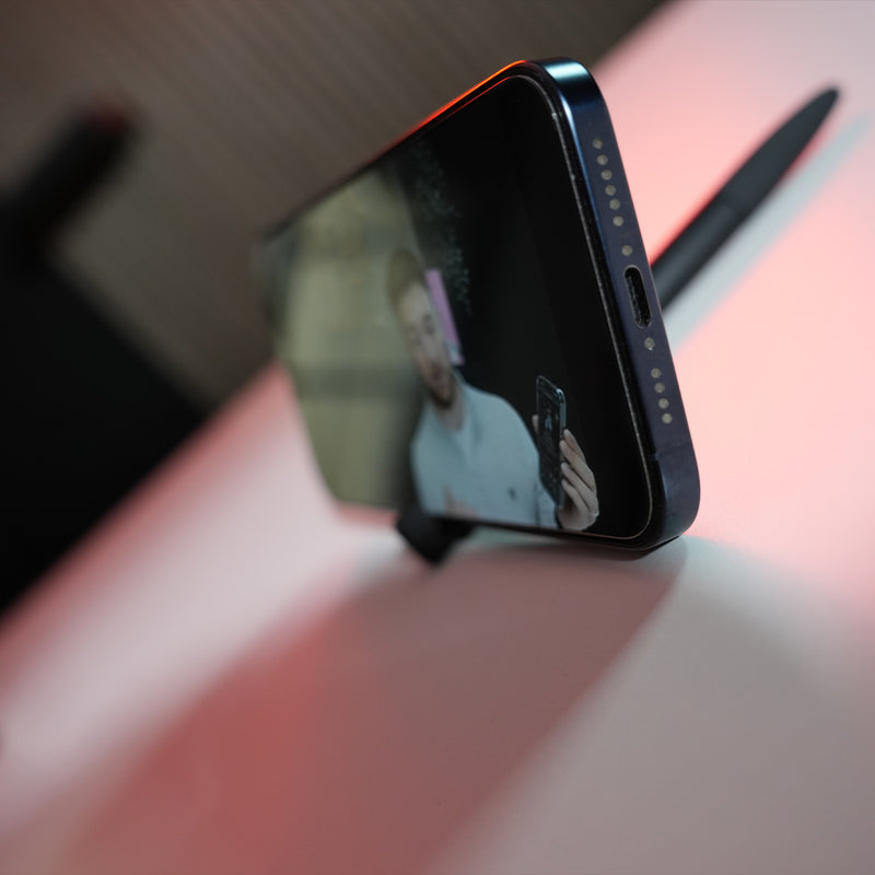 TAPiTAG Smart pen with NFC in sitting in pens phone stand