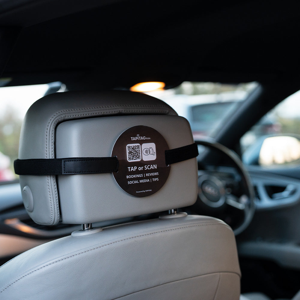 TAPiTAG Ride NFC tag attached to car headrest for contactless bookings, reviews, social media and tips via tap or QR scan