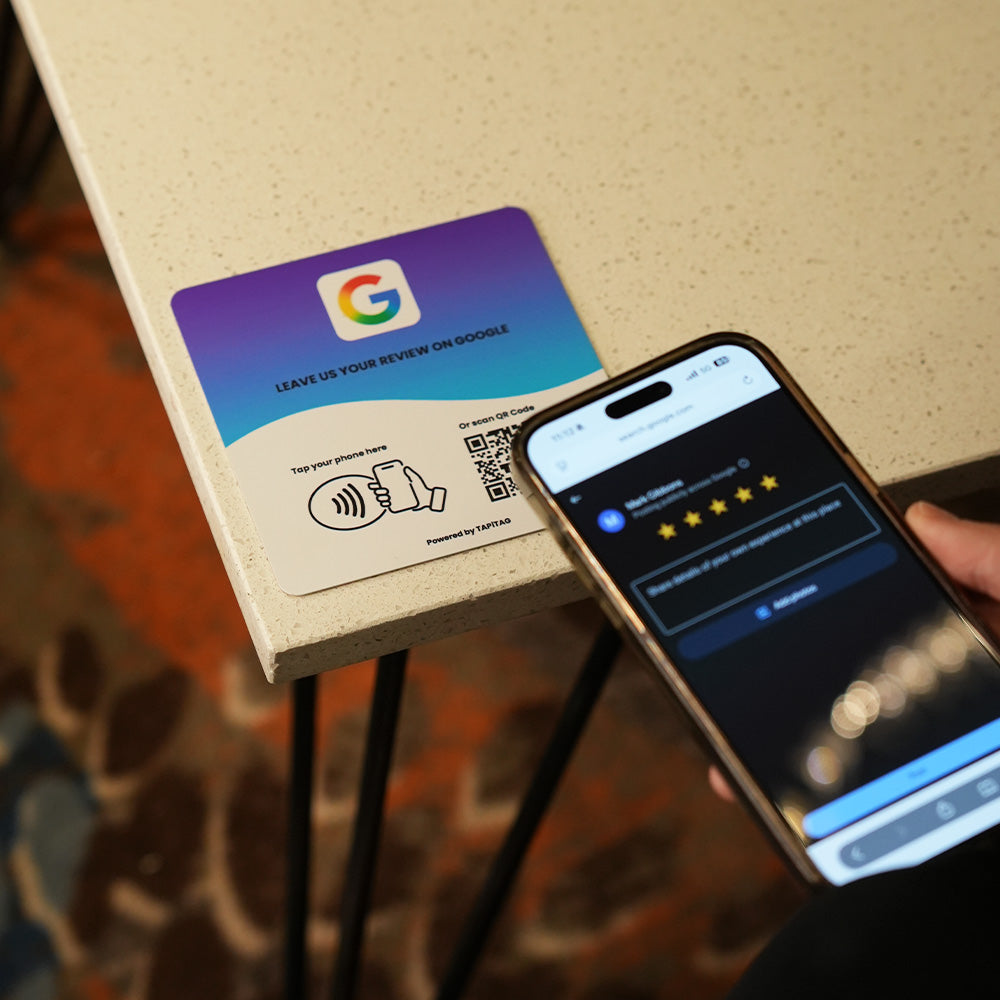 Google Review NFC review plate by TAPiTAG with QR code, allowing customers to tap or scan to instantly review a business on Google, displayed on a white counter.