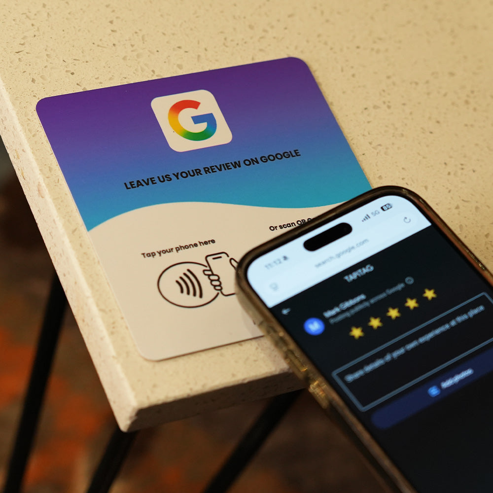 Google Review NFC review plate by TAPiTAG with QR code, allowing customers to tap or scan to instantly review a business on Google, displayed on a white counter.