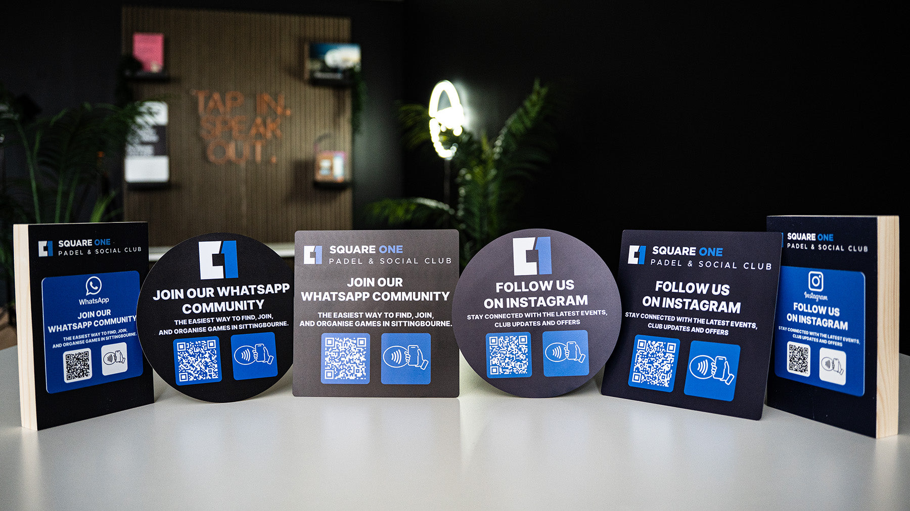 Set of promotional tapItag NFC tags for Square One Padel & Social Club with QR codes on a dark background.