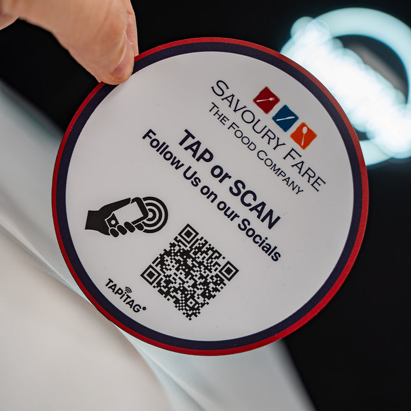 Round label with 'Savoury Fare' branding and QR code on a dark background. Custom Design TAPiTAG with NFC TAG & QR Code. Designed in TAPiTAG Studio. Tag links direct to Google Reviews - TAPiTAG google review tag.