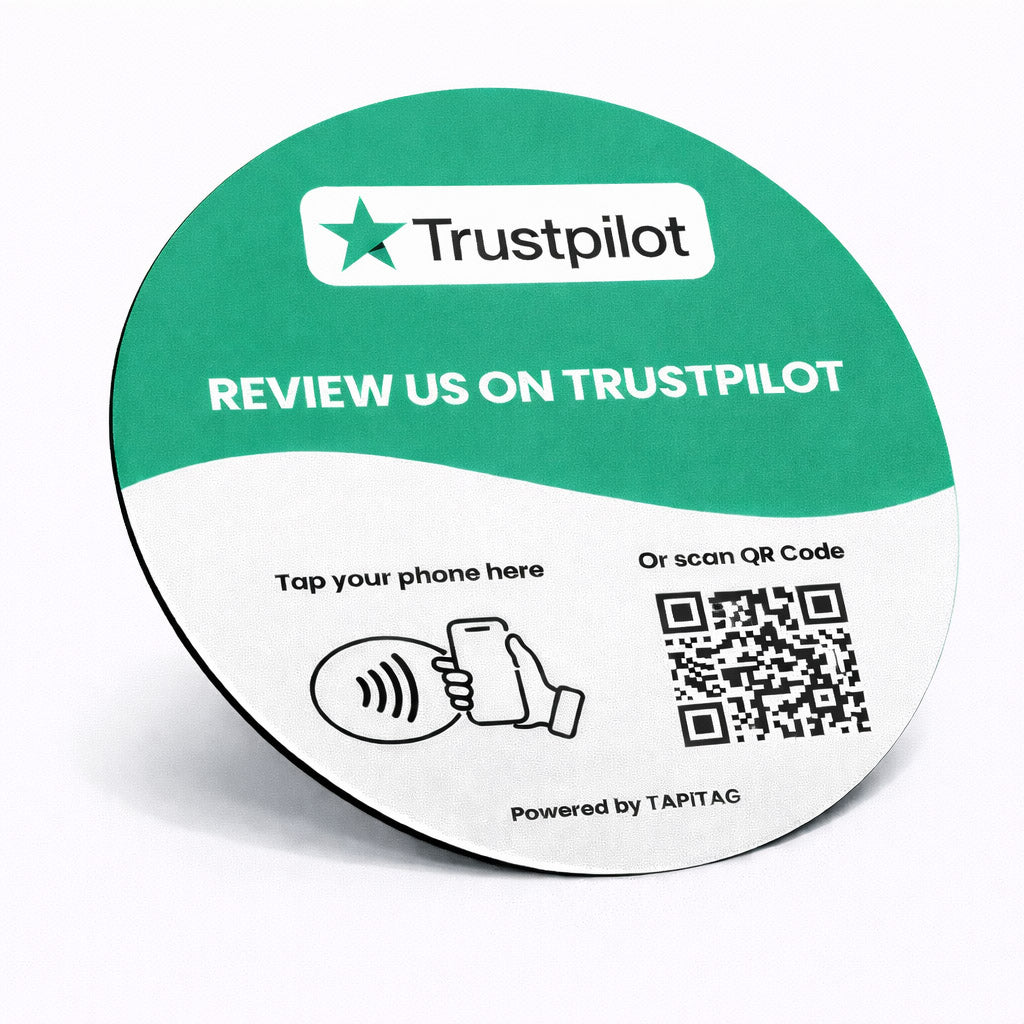 Trustpilot NFC tap-to-follow plate by TAPiTAG with QR code, allowing customers to tap or scan to instantly follow a business on Trustpilot, displayed on a white counter.