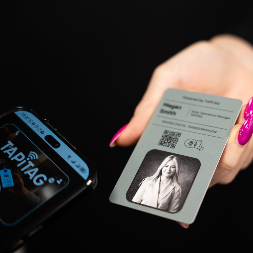 Smartphone displaying a TAPiTAG interface with a TAPiTAG Digital ID Card in the background