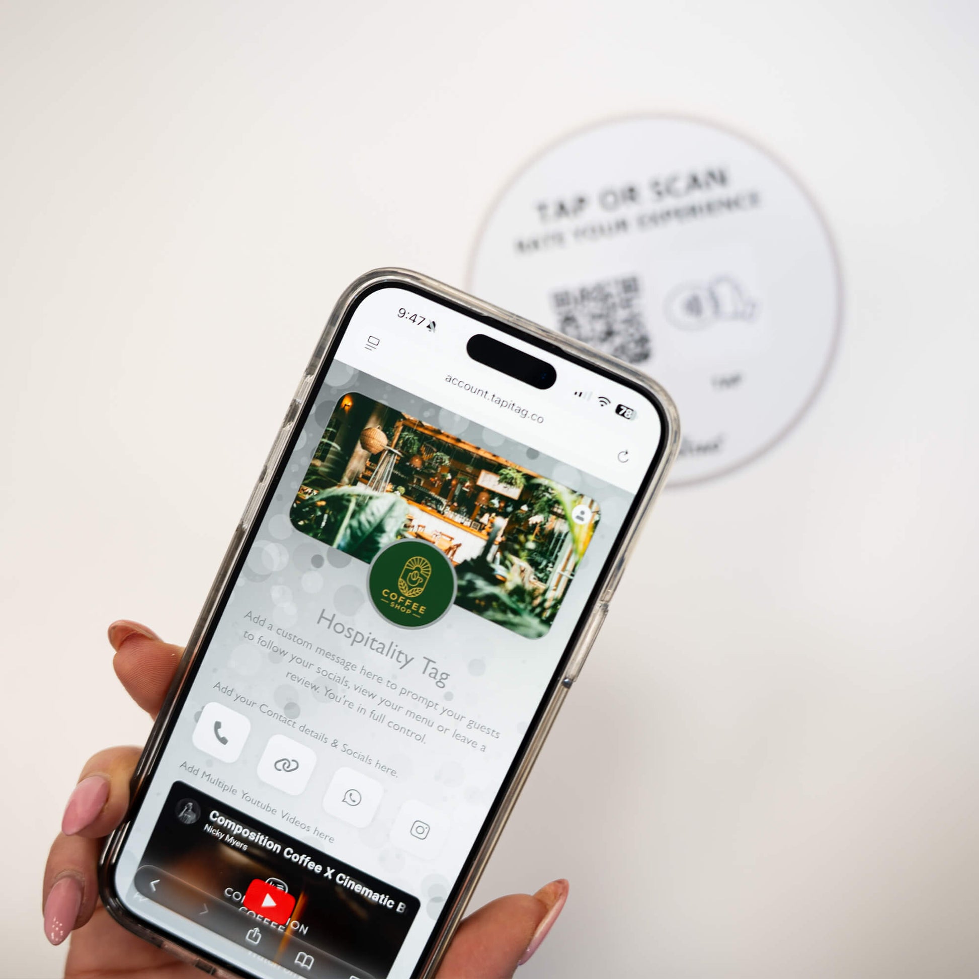 Person tapping TAPiTAG NFC hospitality tag with smartphone to access digital business profile instantly
