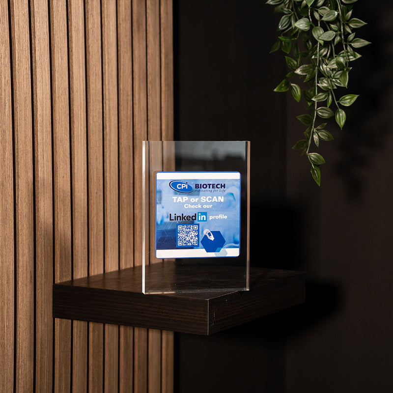 Acrylic sign with CPI Biotech logo on a wooden shelf with a dark background