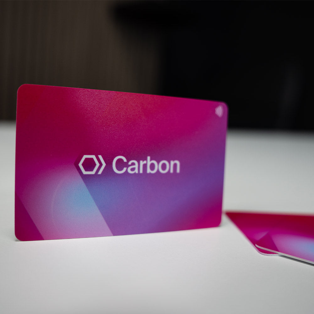 Carbon branded NFC Digital Business card with gradient pink to purple design on a white surface