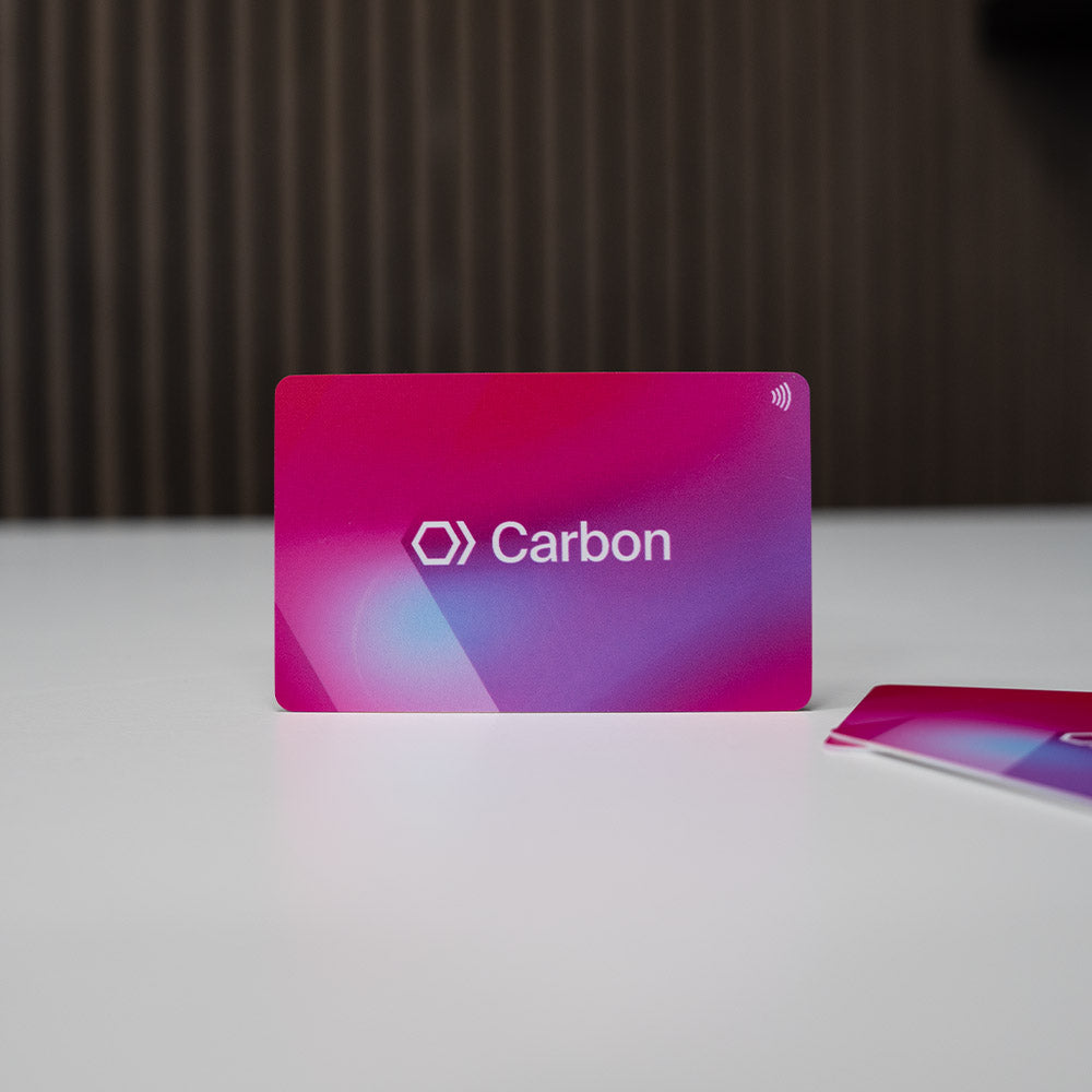 Carbon branded NFC Digital Business card with gradient pink to purple design on a white surface