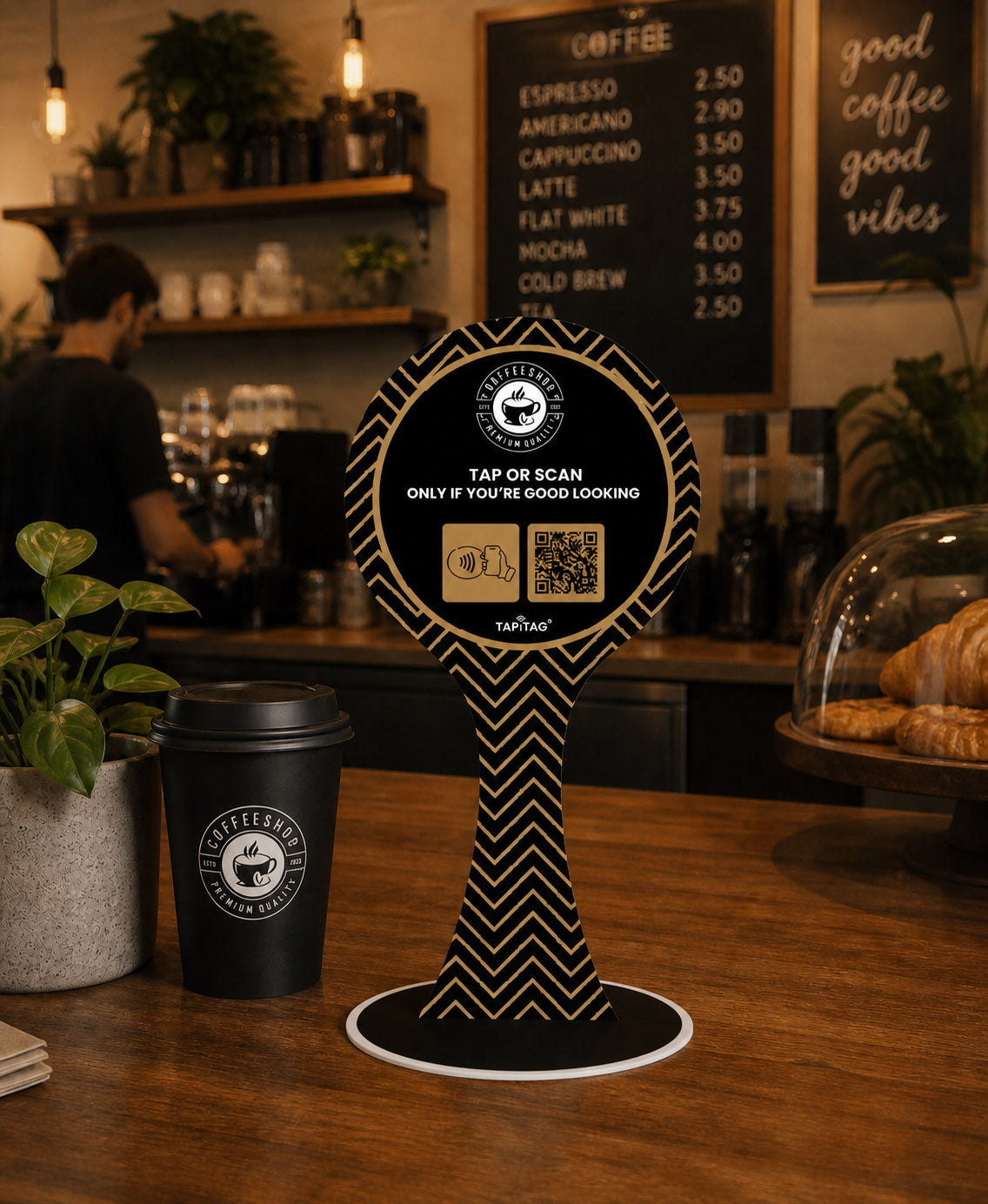 Coffee shop interior with a coffee cup and a sign on a wooden counter.
