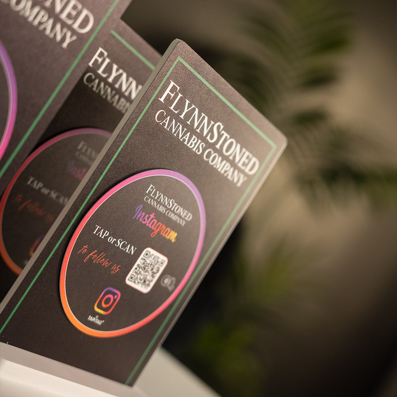 TAPiTAG Smart Display Stand Promotional materials for FlynnStoned NYC Cannabis Company with TAPiTAG NFC TAG & QR code for Instagram social media followers.