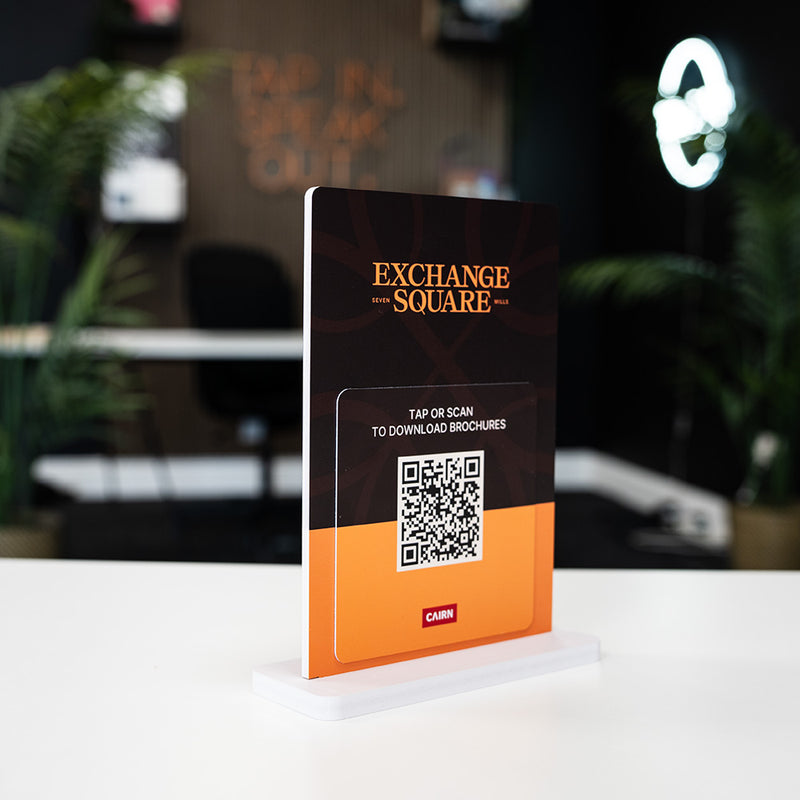 Exchange Square sign with QR code on a stand in an indoor setting