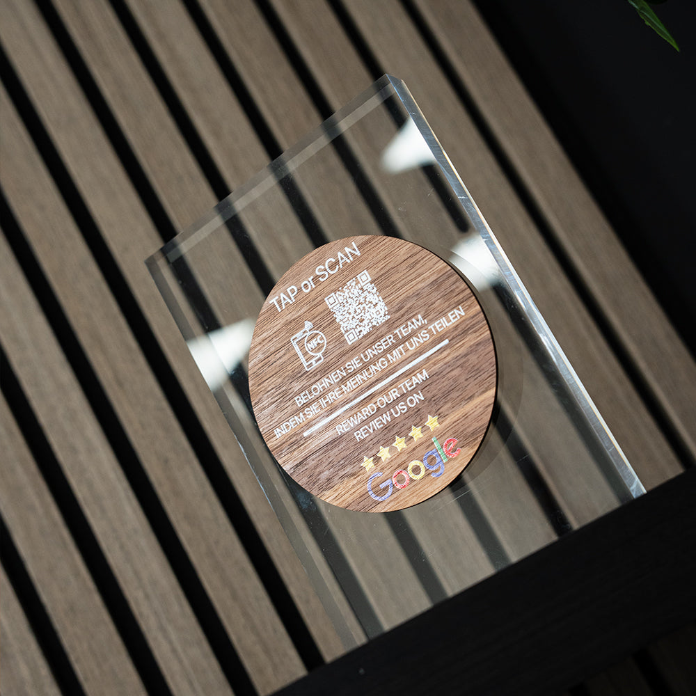 Wooden TAPiTAG NFC TAG with QR code and text on a CLEAR ACYRLIC surface

