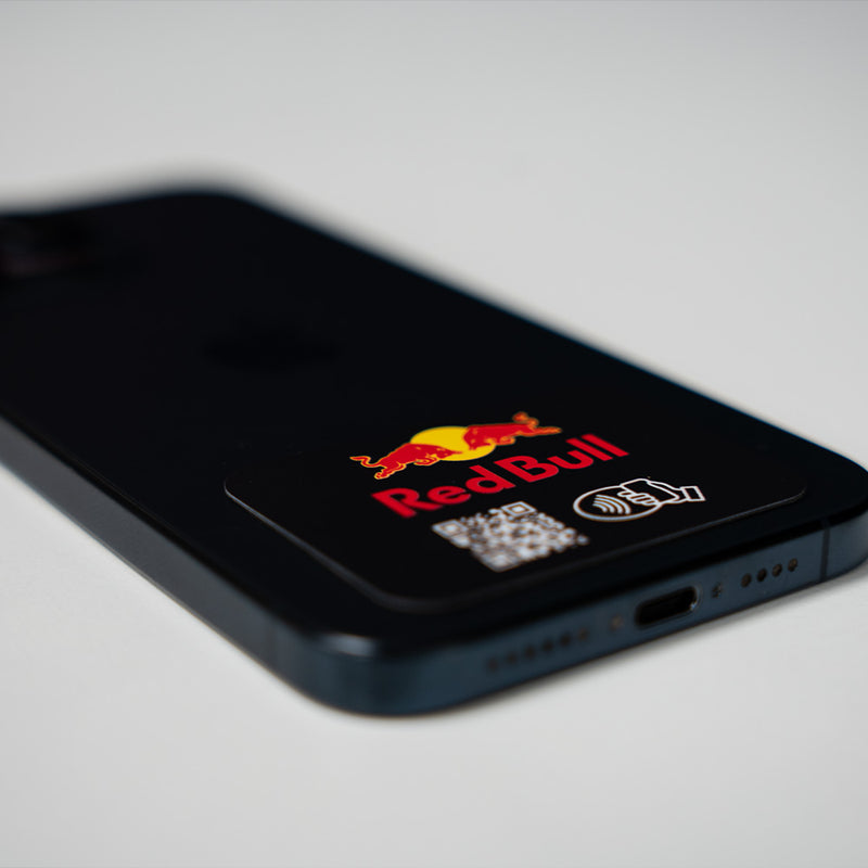 Phone case with Red Bull logo and QR code on a gray background. TAPiTAG NFC QR MINICARD NFC-Enabled Digital Business Card