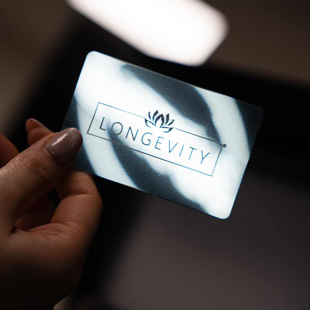 Mirror TAPiTAG Digital Business Card with 'Longevity' printed on it against a dark background
