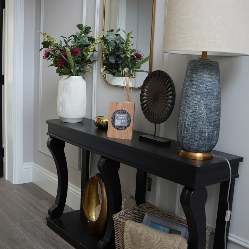 TAPiTAG wooden NFC WiFi stand on a countertop allowing guests to tap or scan a QR code to connect to WiFi instantly.