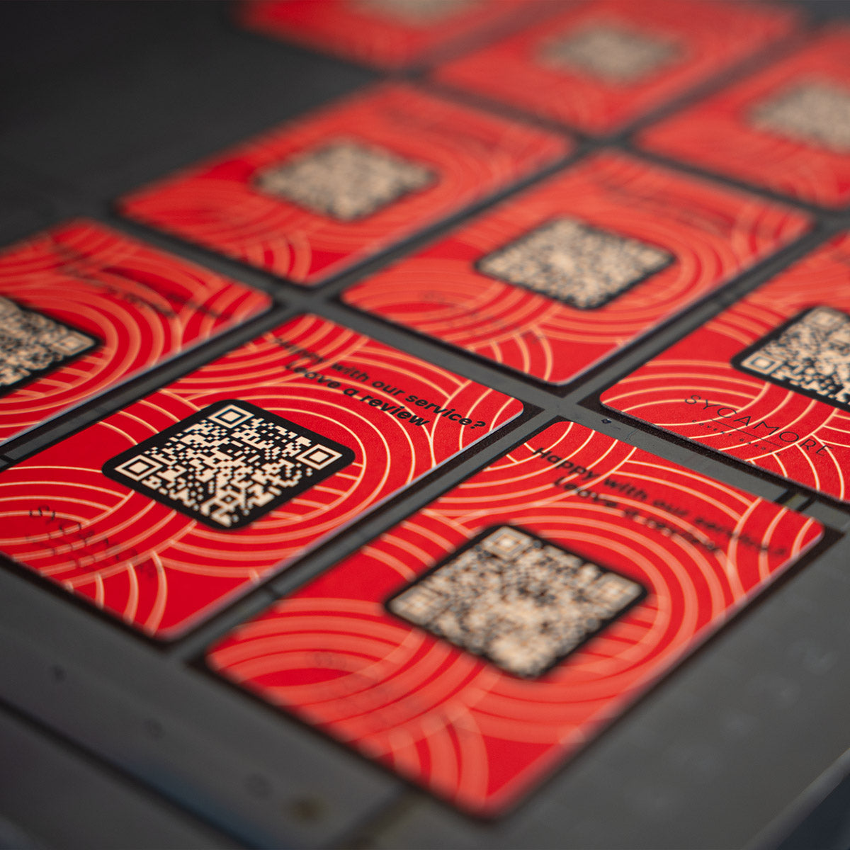 Red tapitag google review cards with QR codes on a dark surface