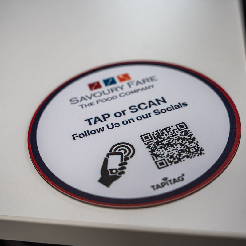 Round label with Savoury Fare branding and QR code on a white surface. Custom Design TAPiTAG with NFC TAG & QR Code. Designed in TAPiTAG Studio. Tag links direct to Google Reviews - TAPiTAG google review tag.